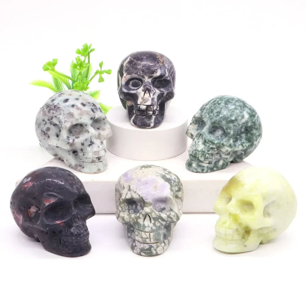 Carved gemstone crystal skull sculpture on a dark surface — view 3 of 12