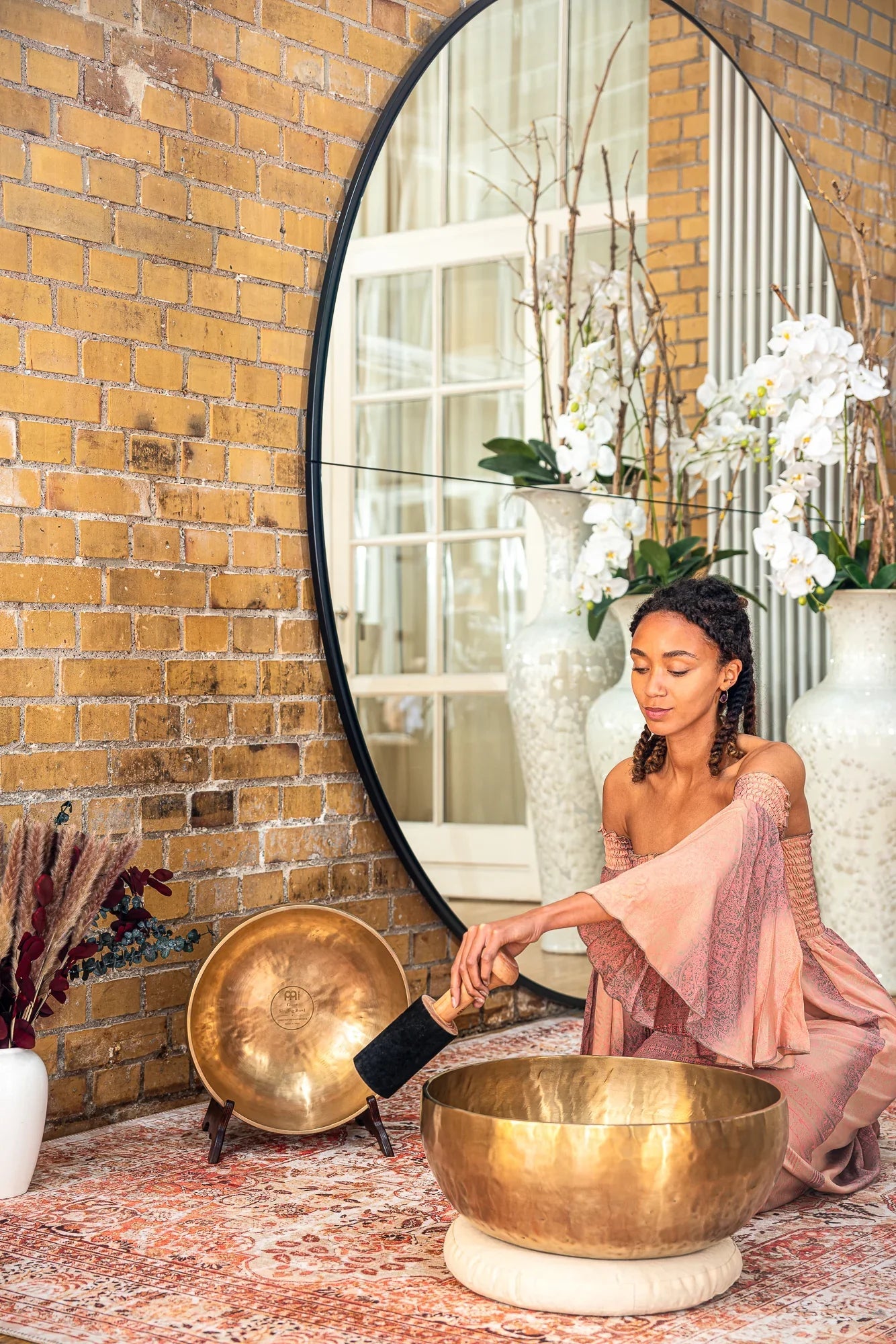 Large hand-forged bronze grounding singing bowl shown in a warm, softly lit styled scene.