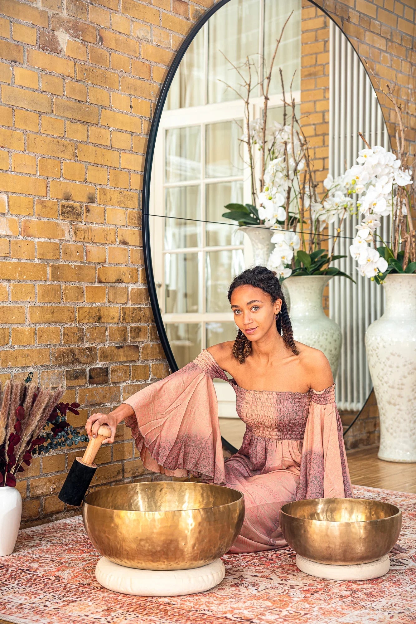 Large hand-forged bronze grounding singing bowl displayed in a calm, styled interior setting.