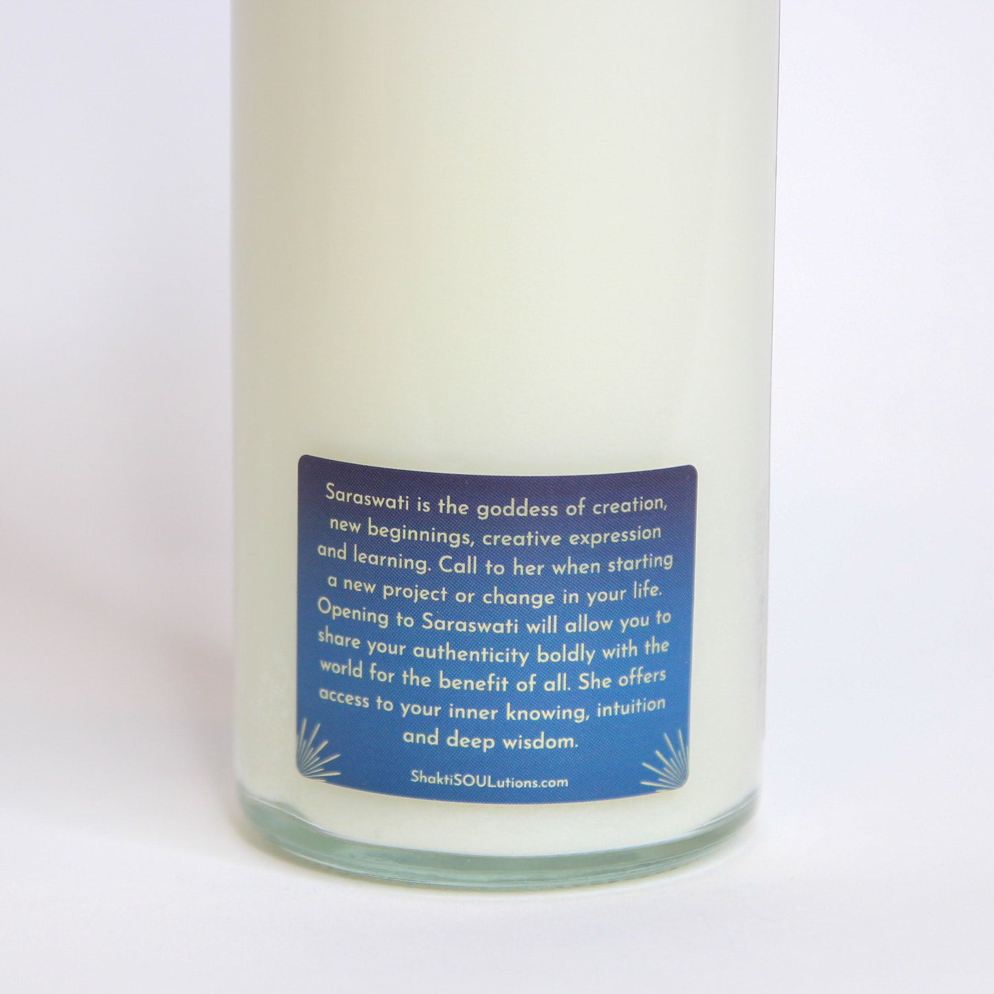 Saraswati Crystal Altar Candle in a 16 oz glass tumbler with an image of the goddess Saraswati on the label and crystals set into the wax — product photo 5