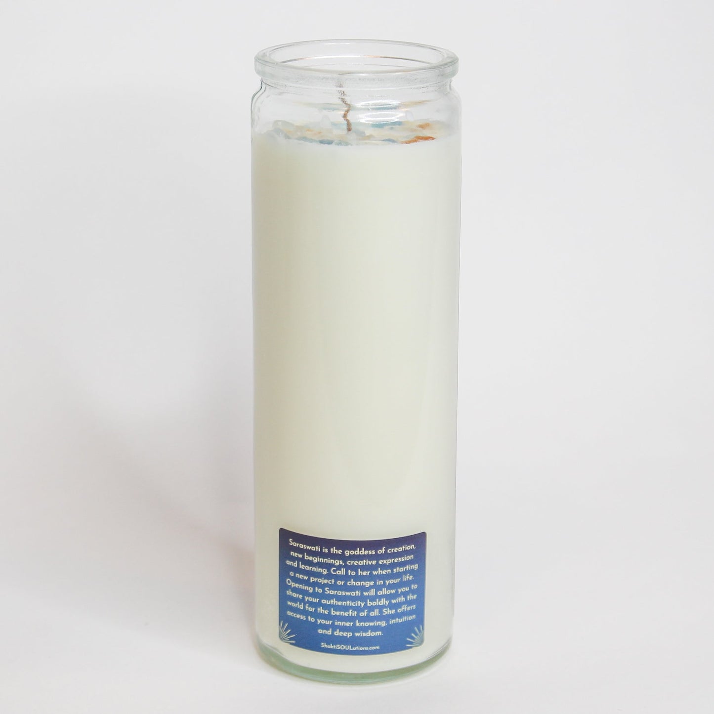 Saraswati Crystal Altar Candle in a 16 oz glass tumbler with an image of the goddess Saraswati on the label and crystals set into the wax — product photo 6