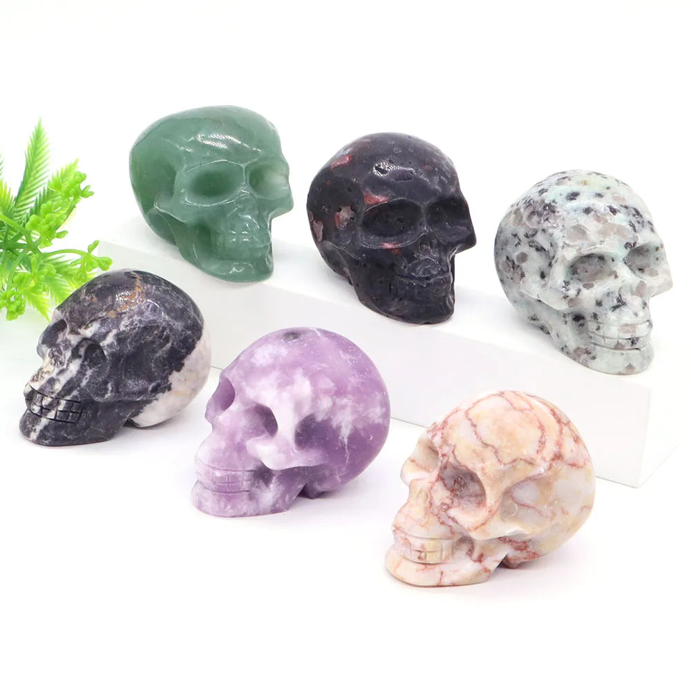 Carved gemstone crystal skull sculpture on a dark surface — view 4 of 12