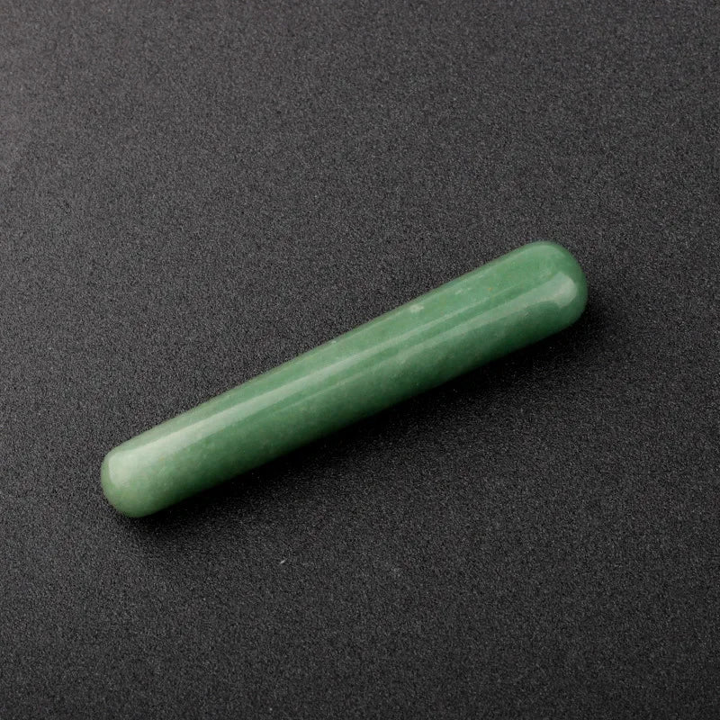 Smooth polished crystal massage wand in assorted gemstones on a dark surface — view 4 of 12