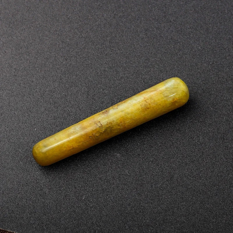 Smooth polished crystal massage wand in assorted gemstones on a dark surface — view 11 of 12