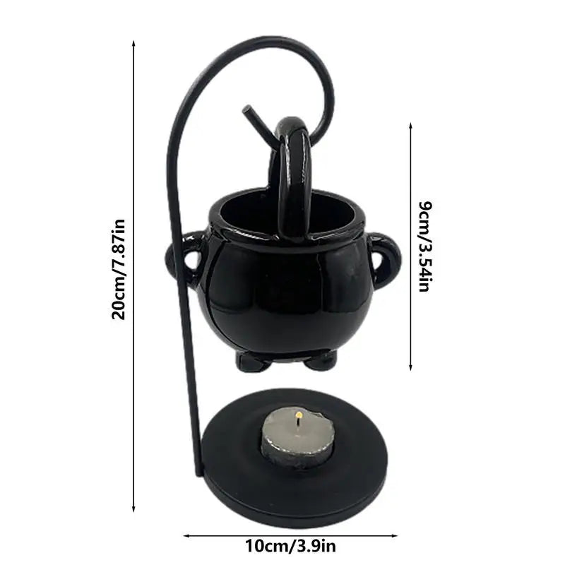 Hanging ceramic cauldron wax burner suspended from a black metal stand — view 3 of 5