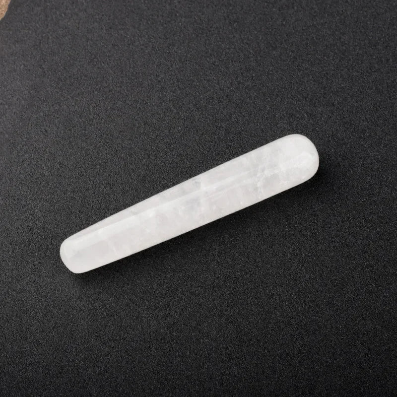 Smooth polished crystal massage wand in assorted gemstones on a dark surface — view 5 of 12