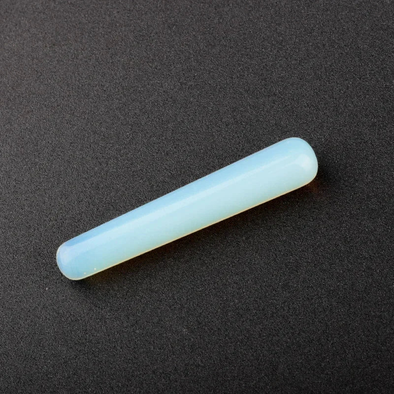 Smooth polished crystal massage wand in assorted gemstones on a dark surface — view 8 of 12