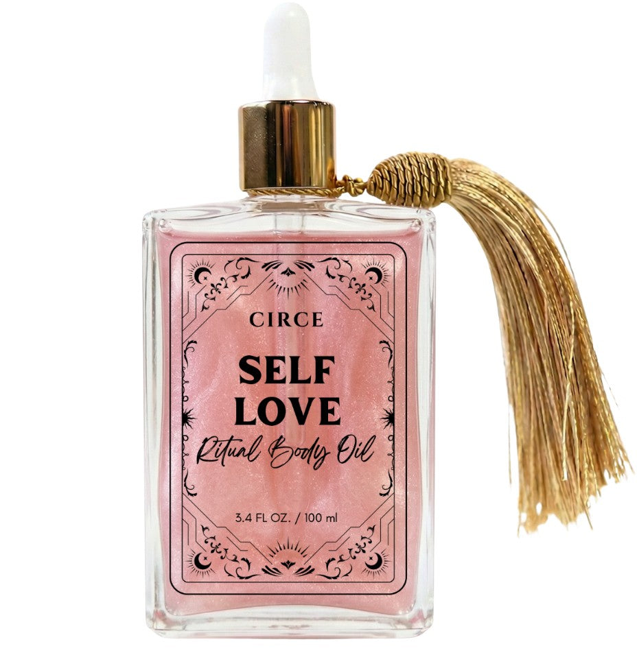 Self Love ritual body oil in an apothecary glass bottle with rose quartz crystals