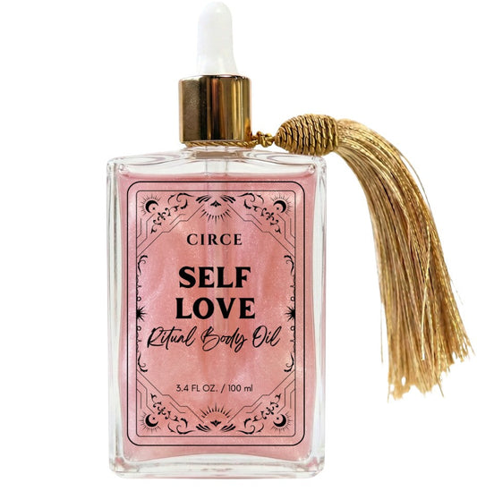 Self Love ritual body oil in an apothecary glass bottle with rose quartz crystals