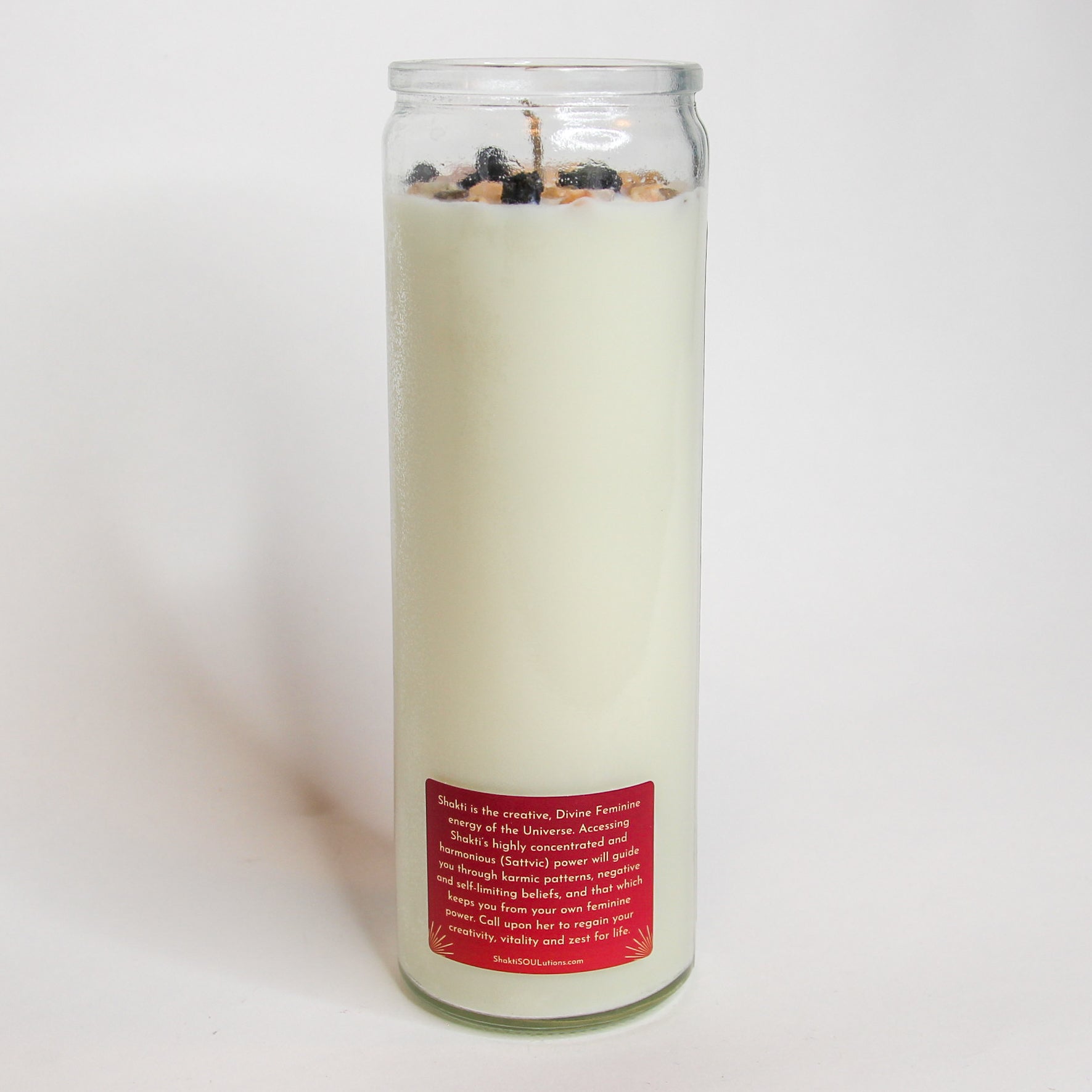 The Shakti Ma altar candle styled on a dark altar surface