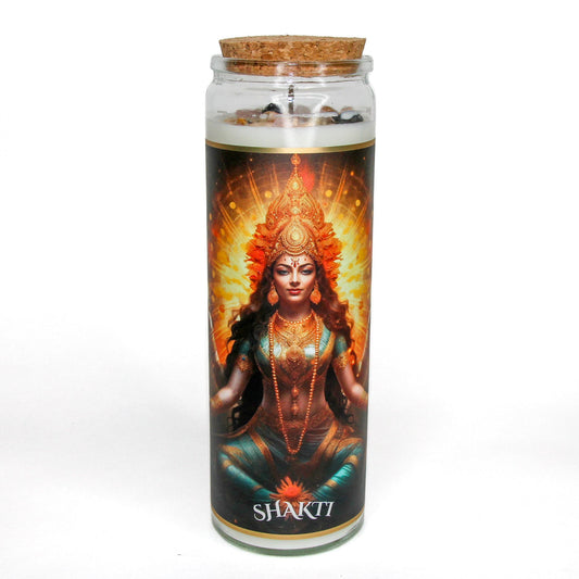 Shakti Ma crystal altar candle in a clear glass vessel, topped with crystals