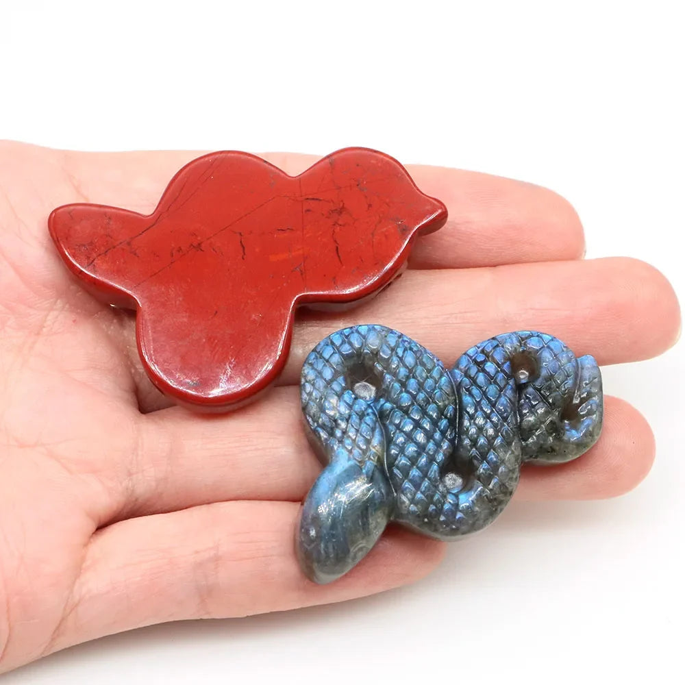 Carved gemstone snake figurine coiled on a dark surface — view 4 of 12