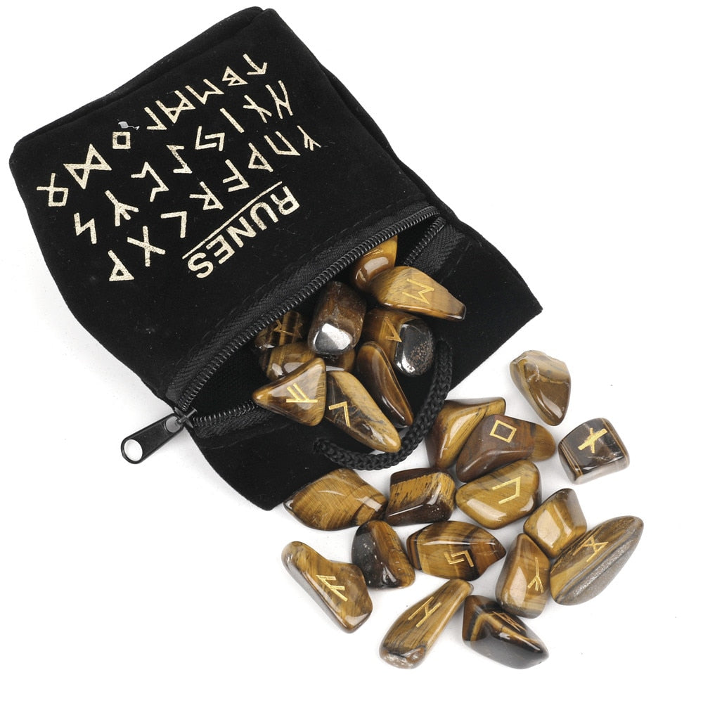 Set of twenty-five carved crystal runes laid out beside a velvet drawstring storage bag — product photo 6