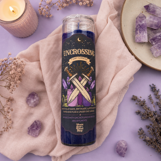A tall deep purple seven-day glass jar candle with an Uncrossing label.