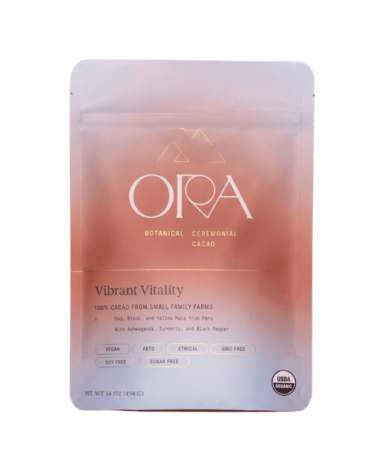 Ora Cacao Vibrant Vitality ceremonial cacao blend shown on a plain neutral background.