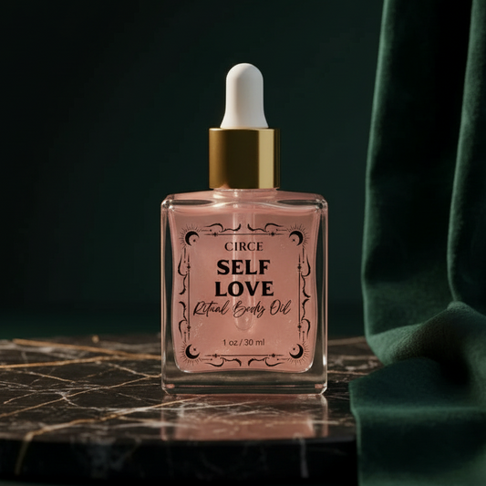 Circe Self Love Ritual Body Oil, 1 oz pink bottle, on black marble against dark green velvet
