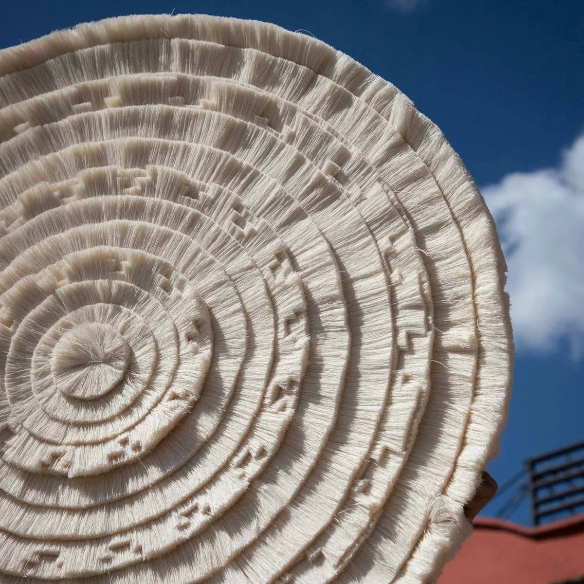 Calendario Azteca tapestry photographed from below against a blue sky
