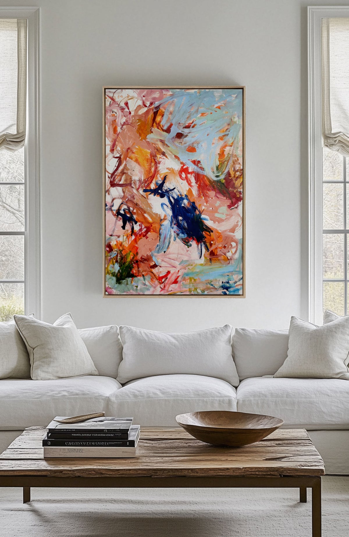 Dream Big canvas hung above a pale sofa in a bright living room