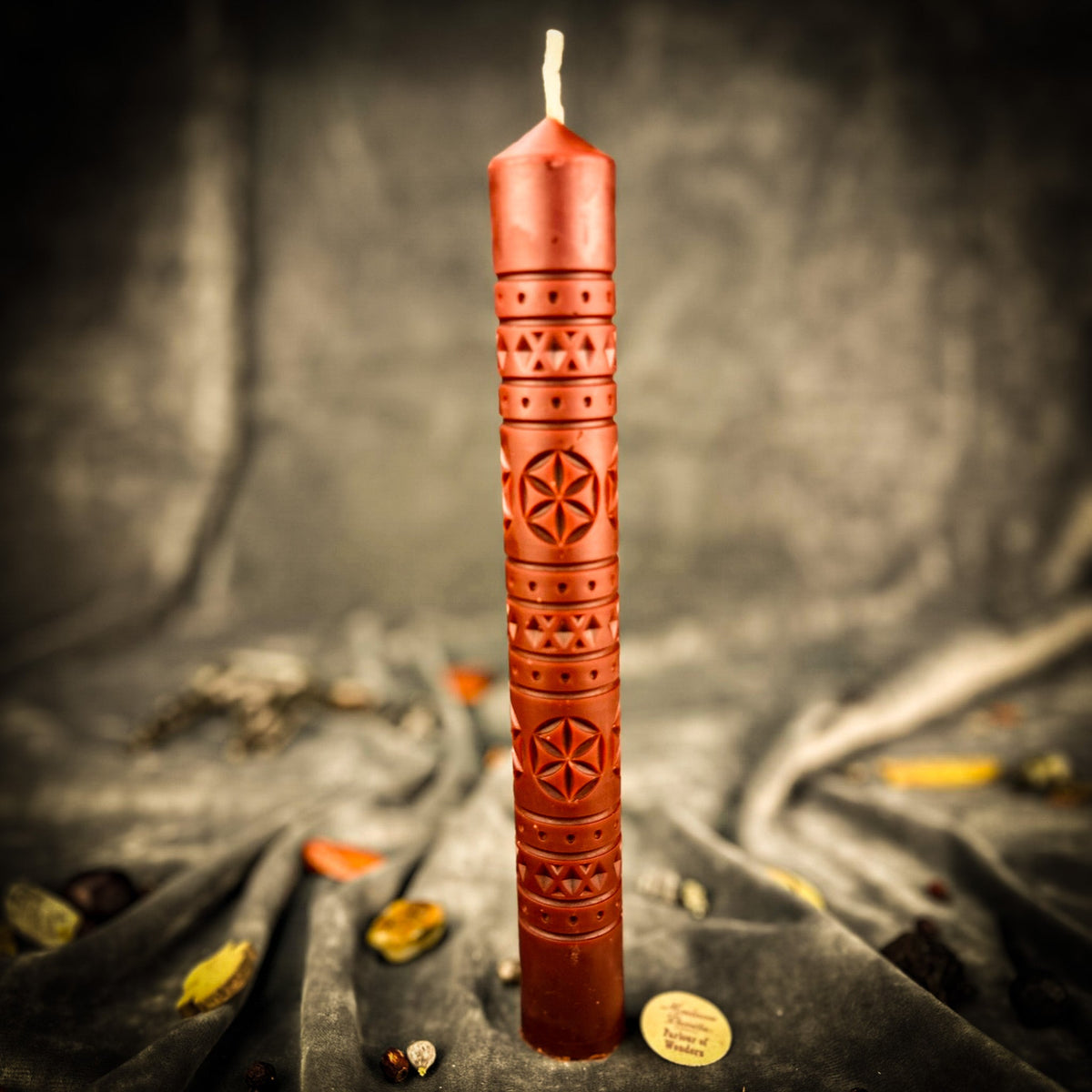 Rozetka rosette beeswax pillar candle in rust brown on draped fabric