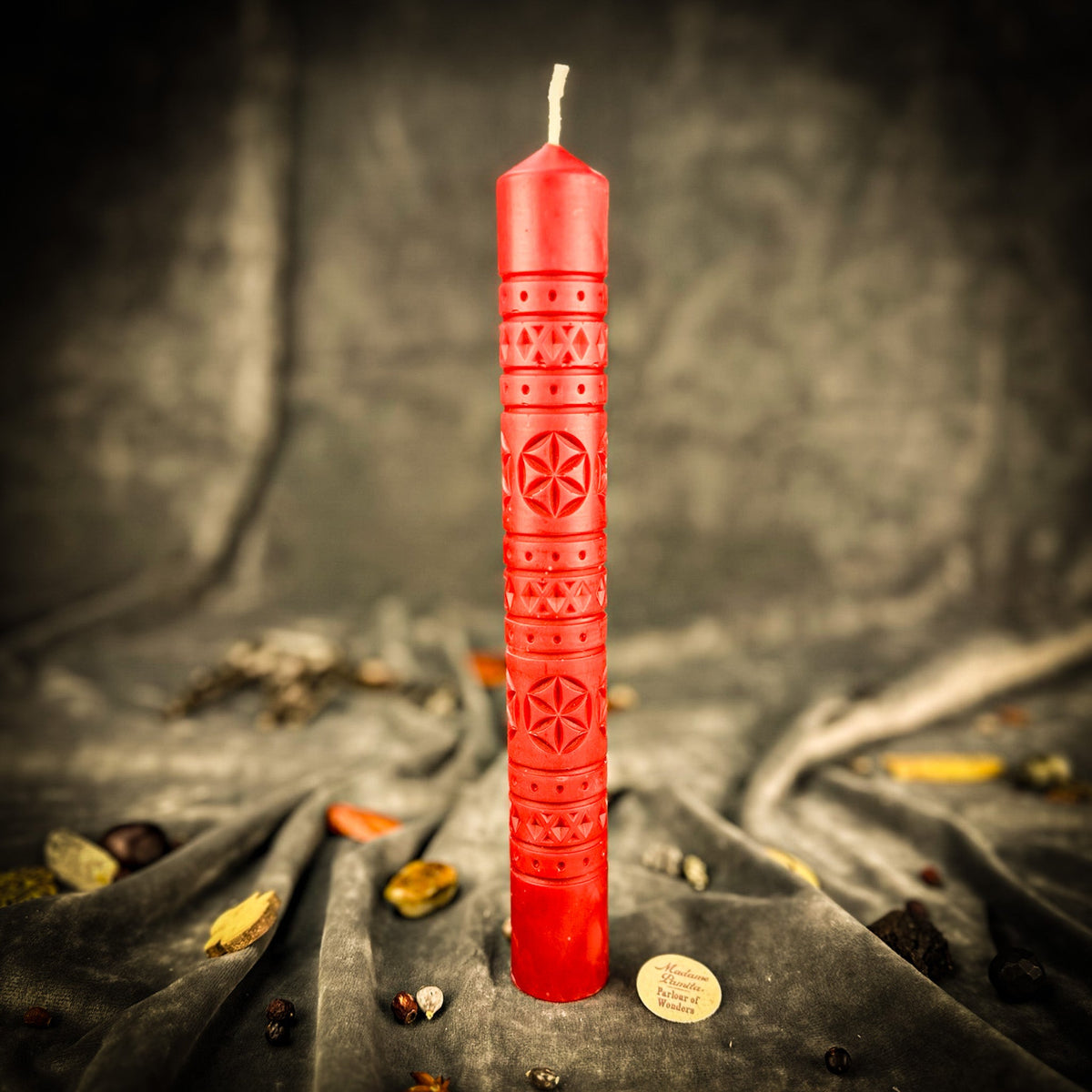 Rozetka rosette beeswax pillar candle in red on draped fabric