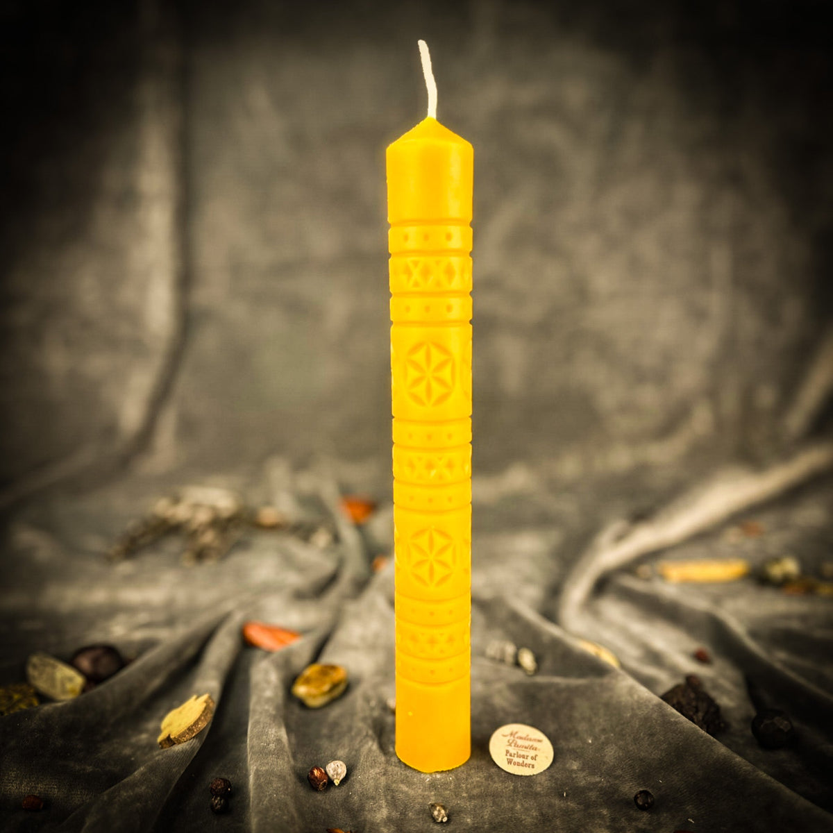 Rozetka rosette beeswax pillar candle in yellow on draped fabric