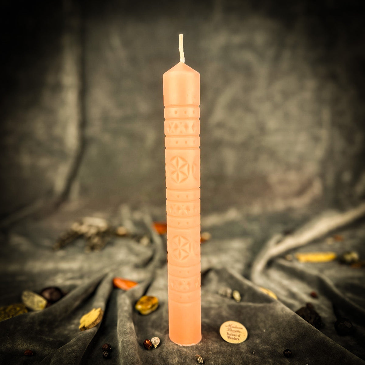 Rozetka rosette beeswax pillar candle in pink on draped fabric