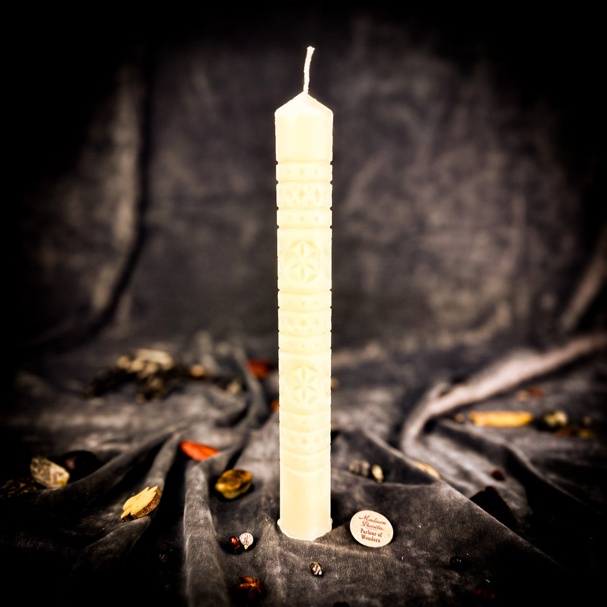 Rozetka rosette beeswax pillar candle in ivory white on draped fabric