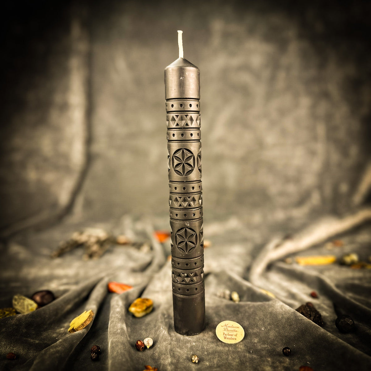 Rozetka rosette beeswax pillar candle in black on draped fabric