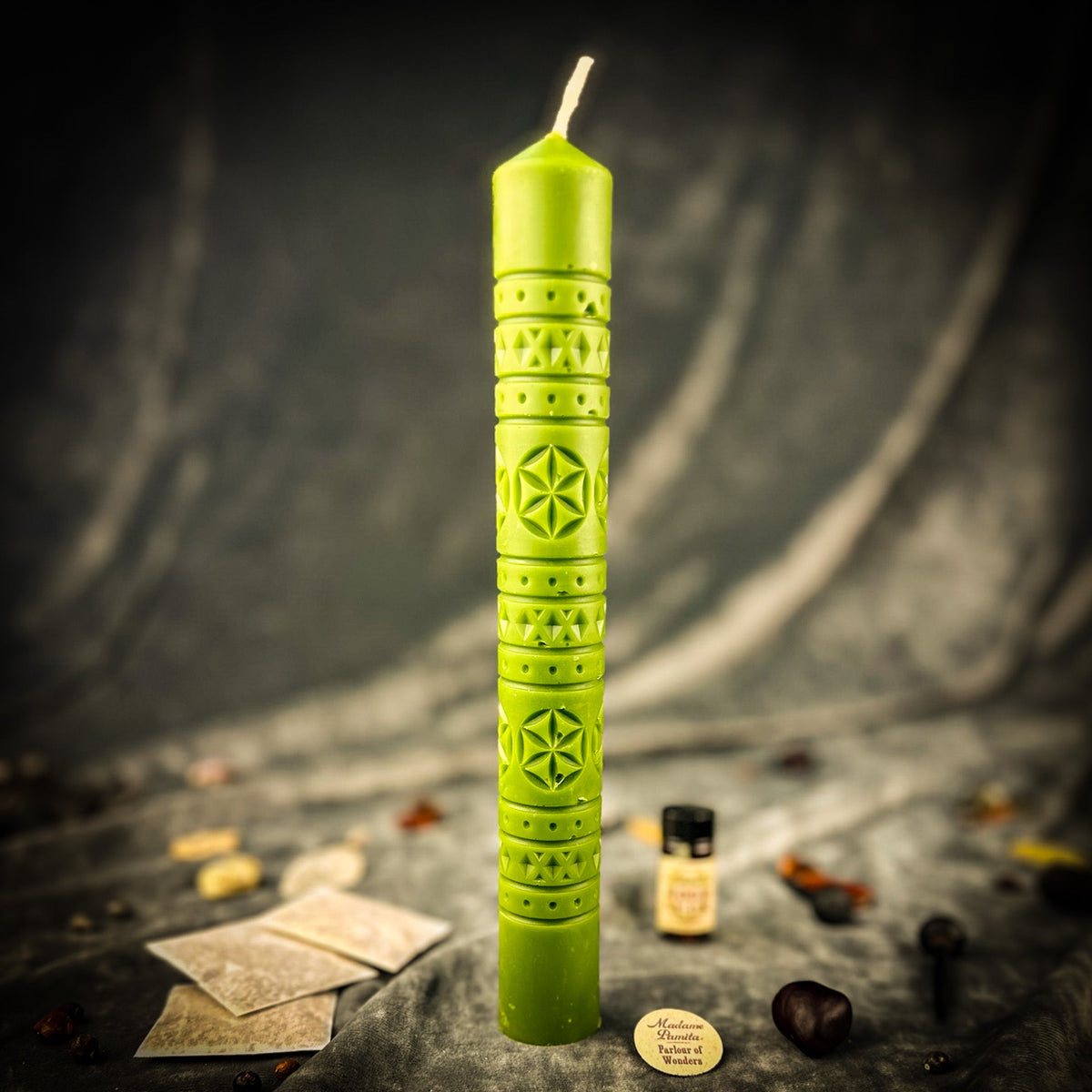 Rozetka rosette beeswax pillar candle in green with kit components on draped fabric