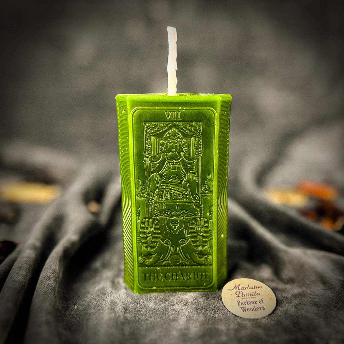 Olive green beeswax The Chariot tarot card candle with THE CHARIOT lettered along its base