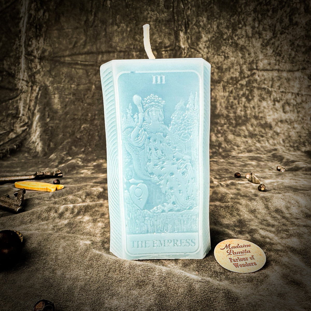Light blue beeswax The Empress tarot card candle with the numeral III at the top