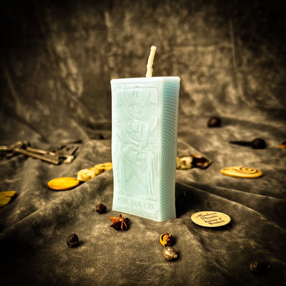 Pale aqua beeswax The Lovers tarot card candle with THE LOVERS lettered along the base