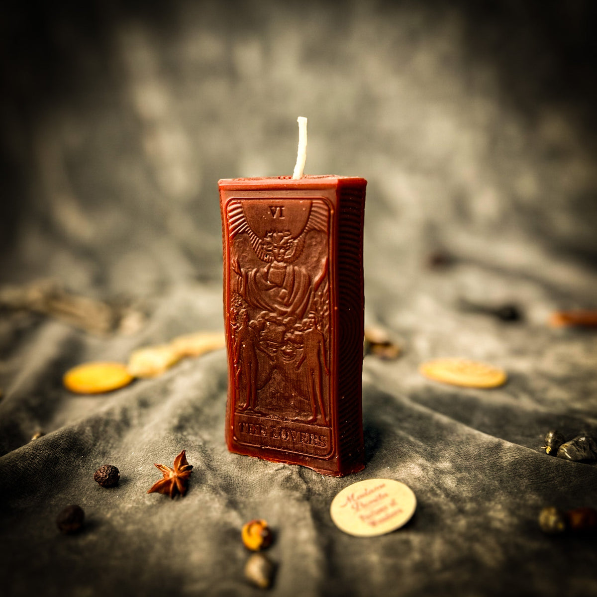 Reddish brown beeswax The Lovers tarot card candle, the two figures raised in relief