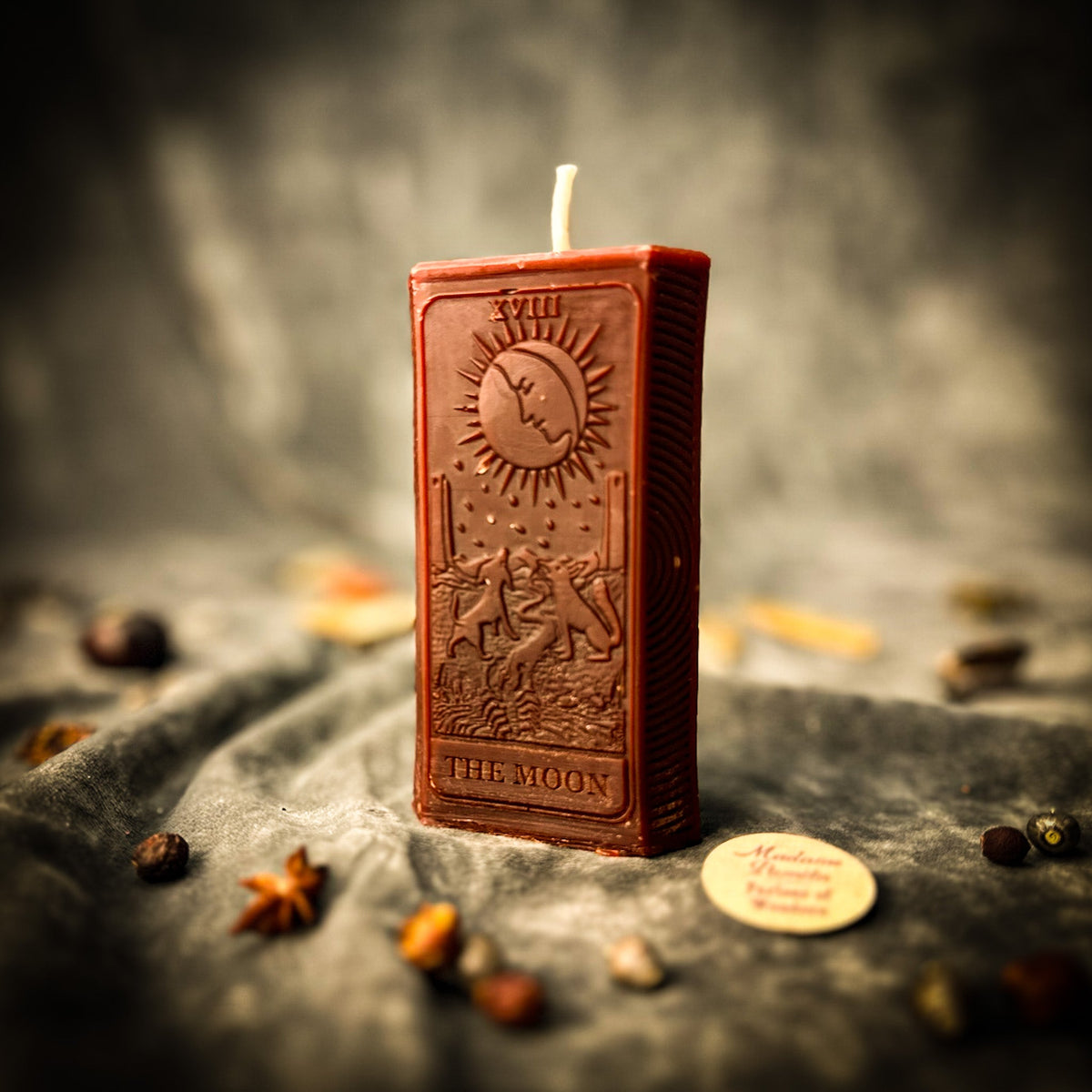 Reddish brown beeswax The Moon tarot card candle, the moon and towers raised in relief
