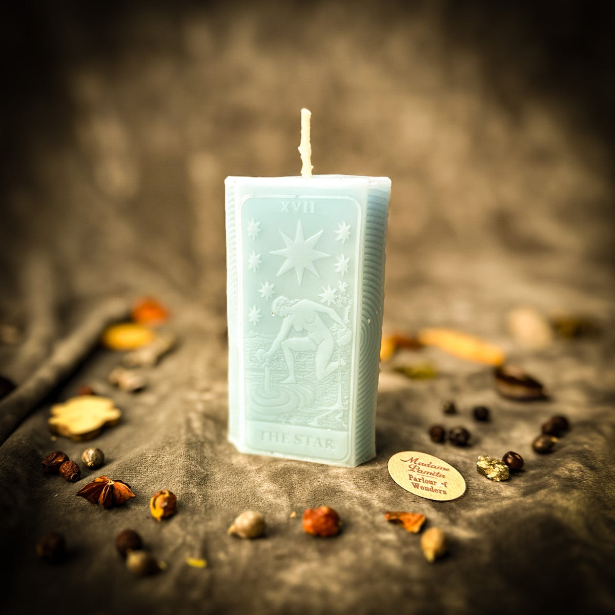 Pale aqua blue beeswax The Star tarot card candle with the star and figure molded in relief
