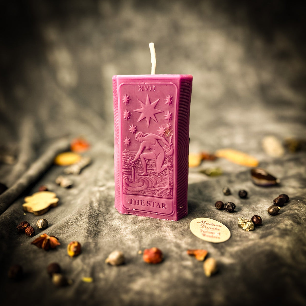 Magenta pink beeswax The Star tarot card candle with THE STAR lettered along the base