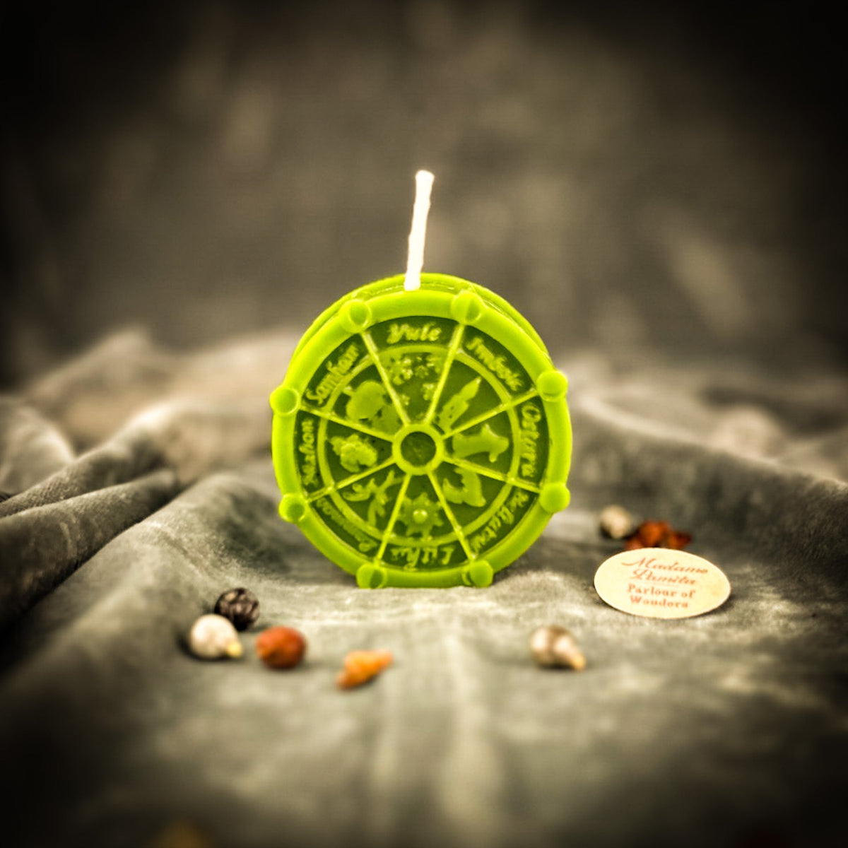 Green Wheel of the Year candle, the wheel spokes raised above the recessed segments.