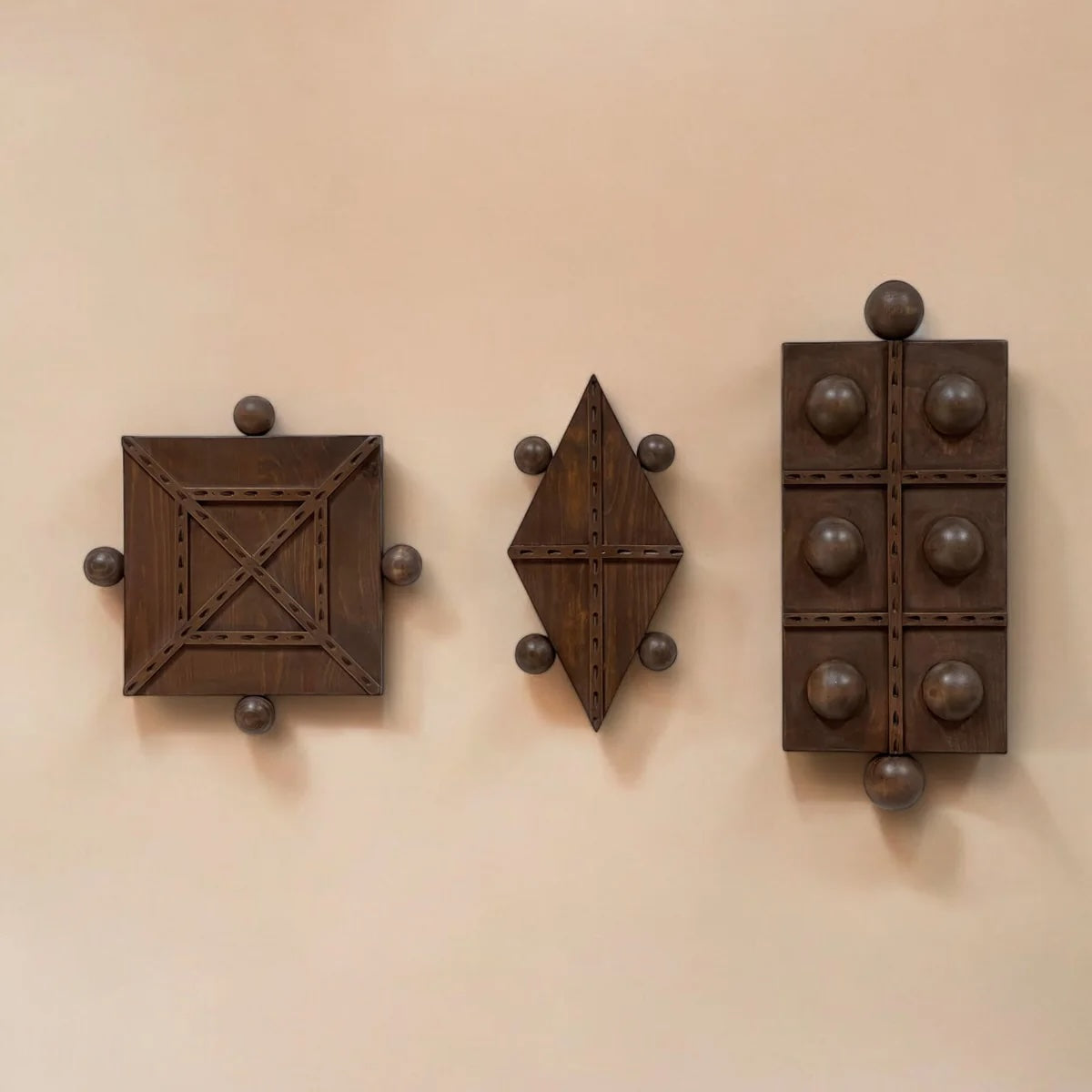 Andre wall panel hung with two companion pieces from the same Honduran workshop