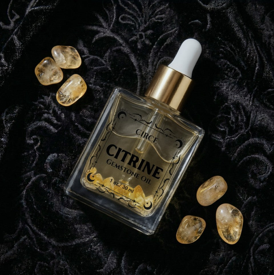 Citrine gemstone shimmer body oil in an apothecary glass bottle with citrine crystals (view 5)