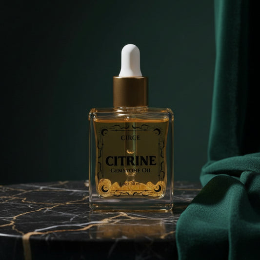 Circe Citrine Gemstone Oil, 1 oz bottle, on black marble against dark green velvet