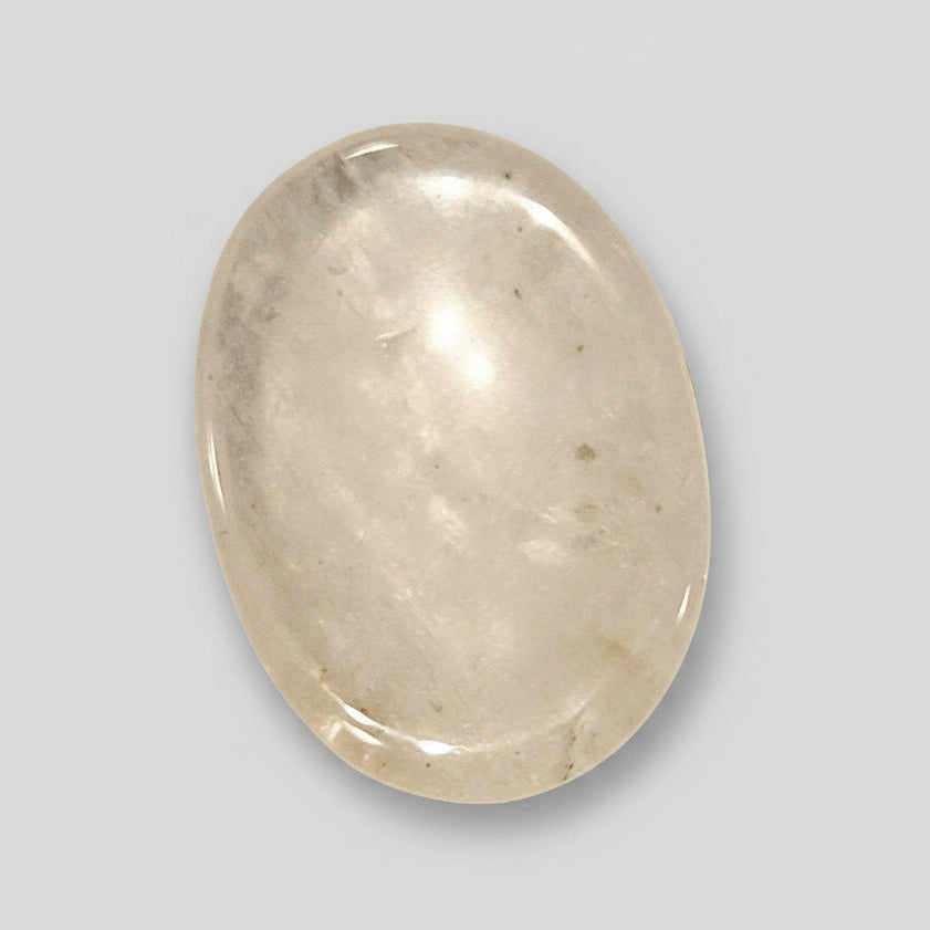 Smooth transparent Clear Quartz comfort stone catching the light like a small prism