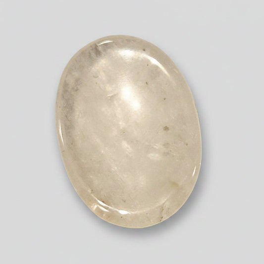 Smooth transparent Clear Quartz comfort stone catching the light like a small prism