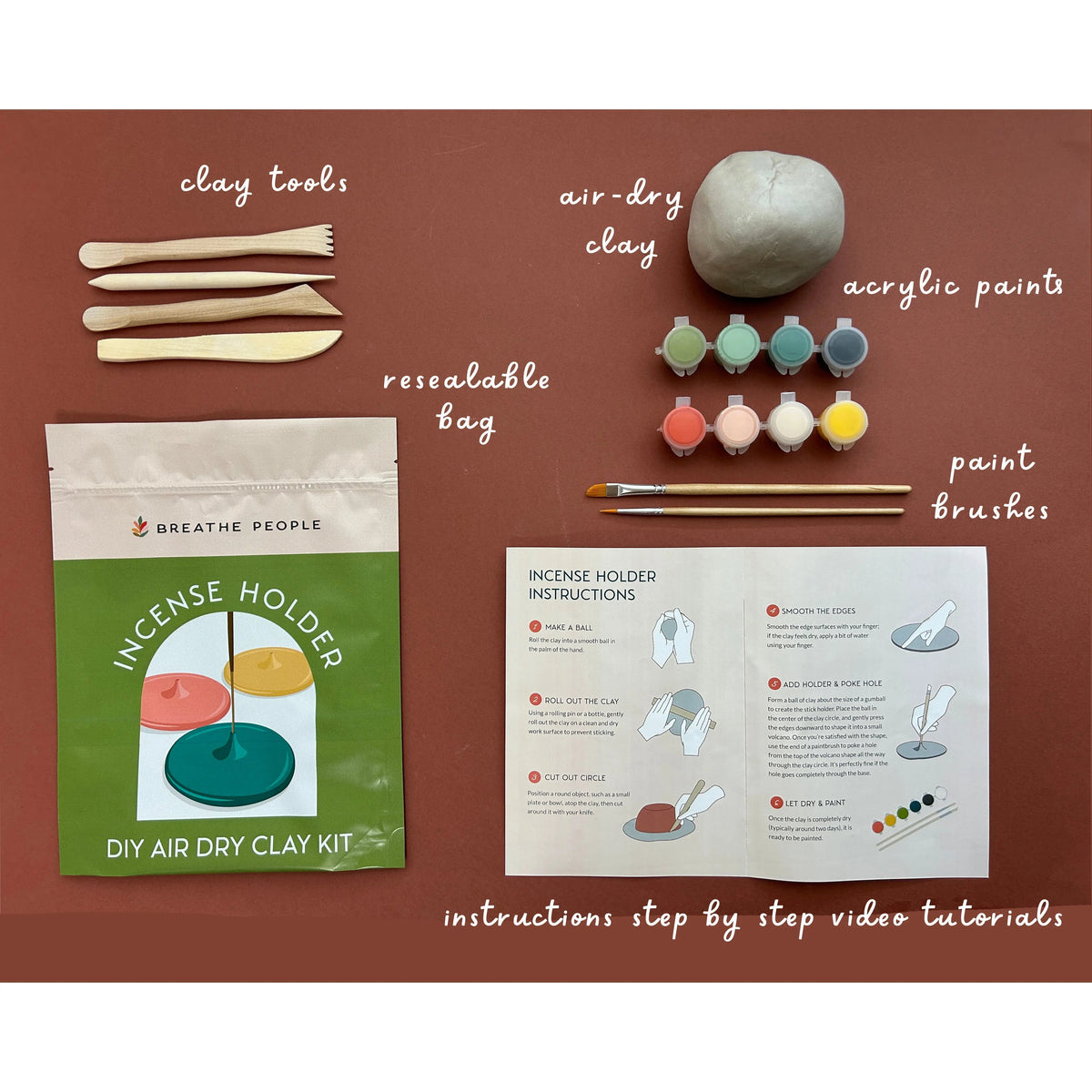 Flat lay of the kit contents: clay tools, air-dry clay, acrylic paints, brushes and instructions