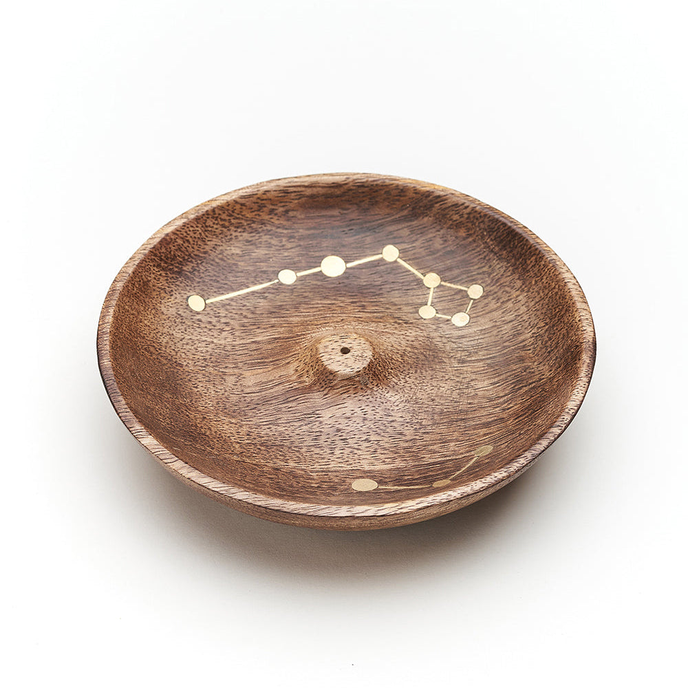 Mango wood incense dish seen at an angle, brass constellation inlay across the bowl