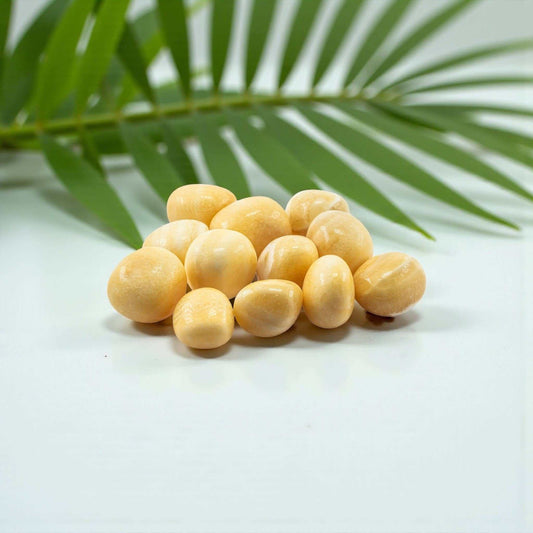 A tumbled yellow aragonite pocket stone in a warm golden-yellow tone.