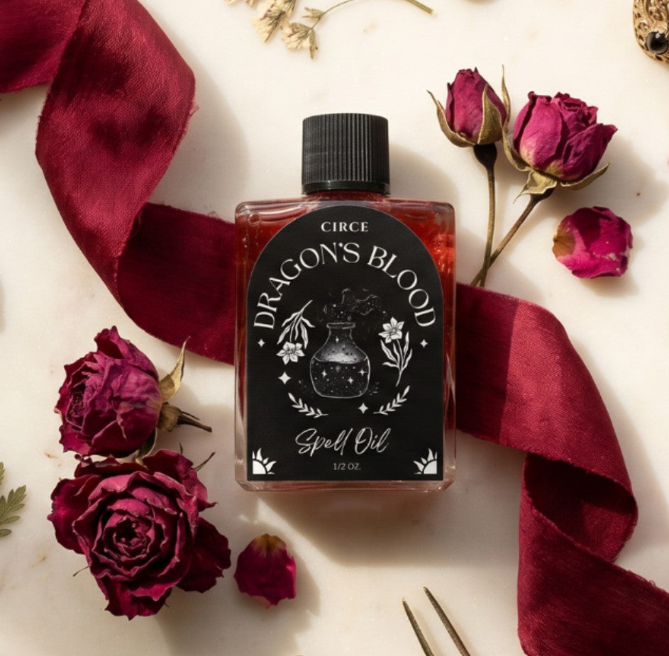 Dragon's Blood ritual oil in a half ounce twist-top glass bottle with resin (view 2)