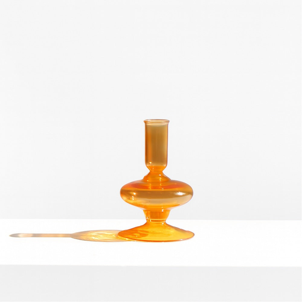 Amber Gigi glass candle holder from the front, showing the tapered candle cup