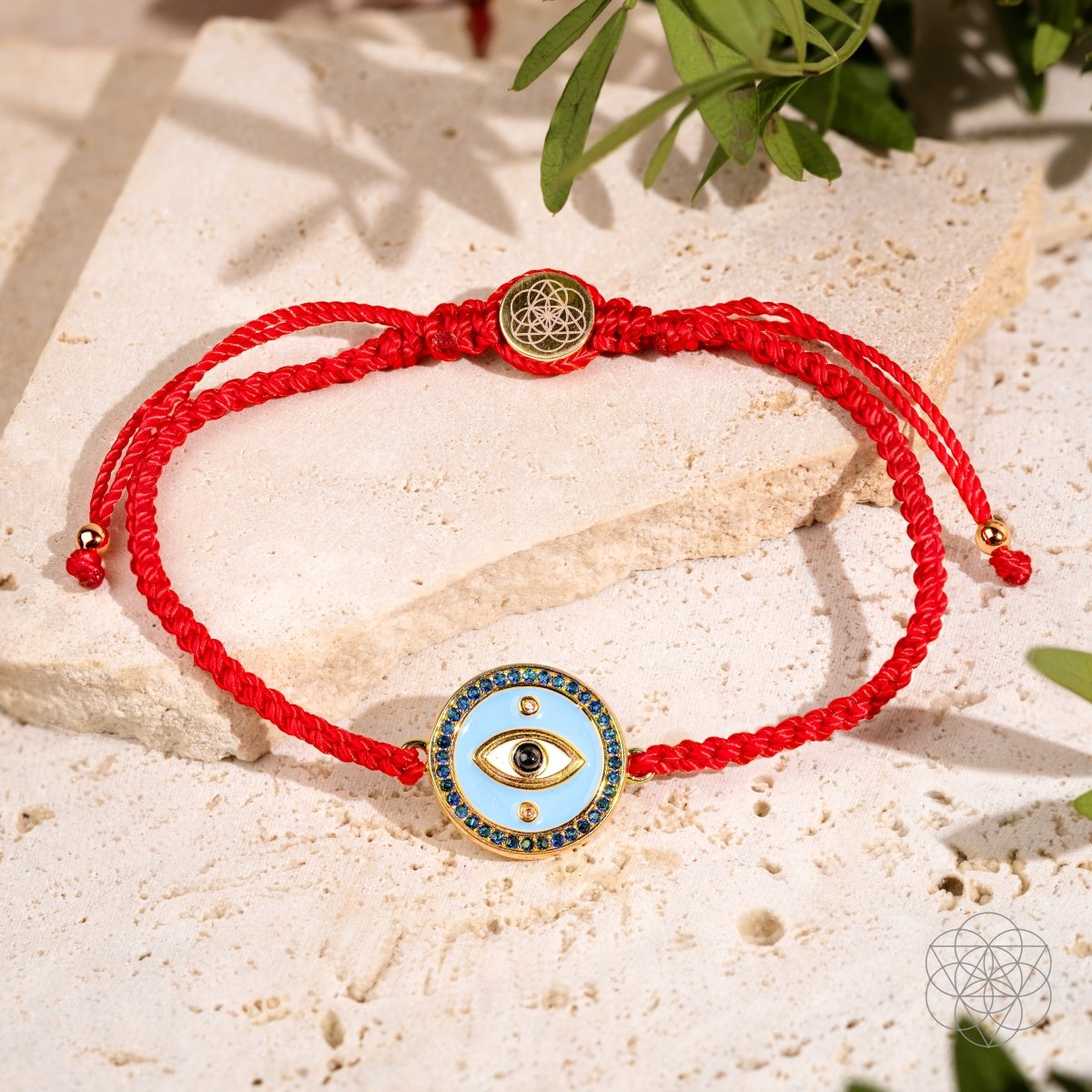 Red string bracelet with a gold-plated Evil Eye charm set with black Onyx
