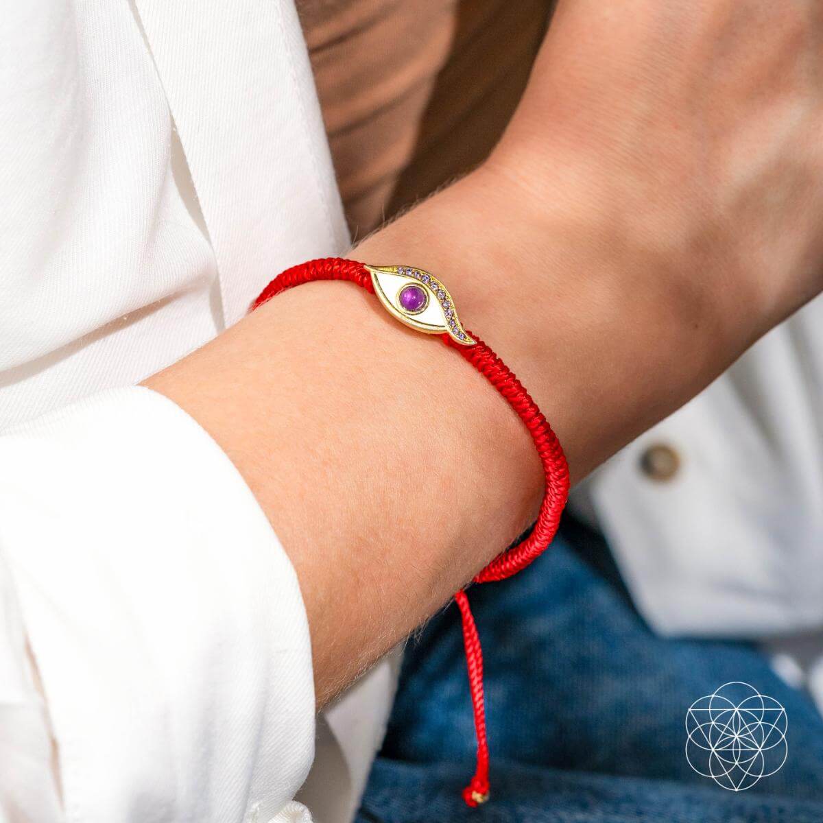 Four-strand red string bracelet with a 14K gold-plated evil eye charm set with a purple amethyst iris — detail view 3