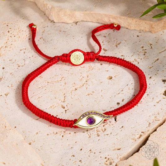 Four-strand red string bracelet with a 14K gold-plated evil eye charm set with a purple amethyst iris